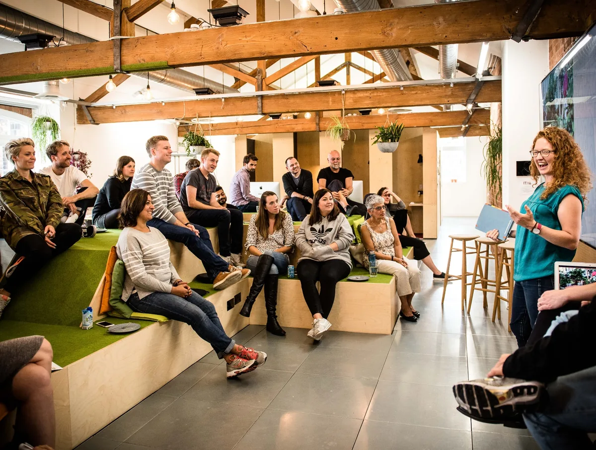 Hermione facilitating a workshop session with a seated audience
